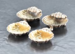 A pair of late Victorian silver scallop shell-form salts, each having three ball feet, marks for