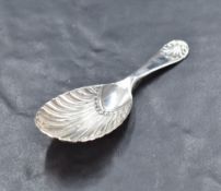 An Edwardian silver caddy spoon, of scalloped oval form, the short handle with scalloped terminal,