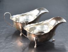 A pair of George V silver sauce boats, of traditional design, marks for Birmingham 1932 and 1934,