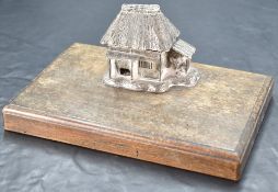 An interesting Japanese Meiji period white metal inkwell, moulded in the form of a thatched