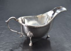 An early Elizabeth II silver gravy boat, of traditional form, marks for London 1957, maker S J