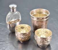 A white metal liqueur tot, of tapering cylindrical form with reeded band and flared rim, marked