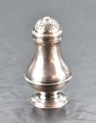 A George II silver sugar dredger/caster, having a domed and pierced pull-off cover over the baluster