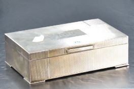 A George VI silver cigarette box, of hinged rectangular form engine-turned throughout, having