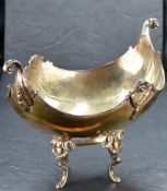 An impressive George V silver fruit bowl or centre-piece, of dished oval boat form with opposing