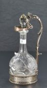 A late Victorian electro-plated bottle/decanter stand, having a scrolled acanthus and lion mask