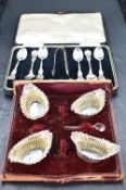 A set of six sterling white metal coffee spoons and matching sugar tongs, the handles of shaped form