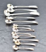 A group of thirteen silver condiment spoons, four being George III, the remainder later, gross