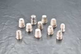 A white metal thimble, unusually decorated with rabbits and marked 'silver' sold along with a