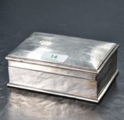 An early 20th century silver cigarette box, of hinged rectangular form with slightly domed cover
