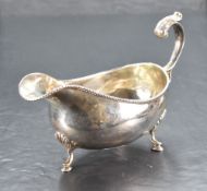 A 1970's Irish silver gravy boat, of traditional design with gadrooned rim, scrolled handle and