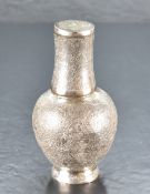 A Persian or middle eastern white metal carafe and cup, having a flared cylindrical neck over a