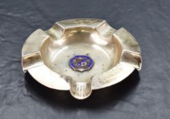 A George V silver and enamel ashtray, of dished circular form with five moulded 'rests' and
