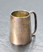 A late Victorian silver christening tankard, of spreading cylindrical form with simple tubular