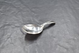 A George III silver caddy spoon, having an oval bowl and string moulded handle, marks for London