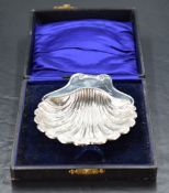A cased Edwardian silver scallop shell-form butter dish, with clear glass liner, lacking knife,