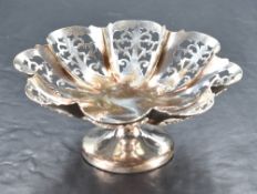 A George V silver bonbon dish, of dished and lobed circular form with pierced decoration, raised