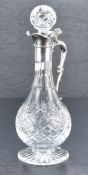 A Queen Elizabeth II silver mounted cut-crystal claret jug, having a star-cut spherical stopper over