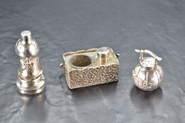 A Japanese sterling grade white metal inkwell, of rectangular form with embossed foliate decoration,