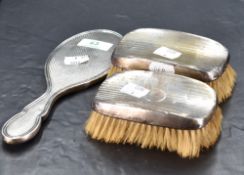 A George VI silver brush mount, with reed moulded and engine-turned decoration, marks for Birmingham