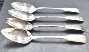 A group of four Georgian silver fiddle pattern serving spoons, each with engraved initials and