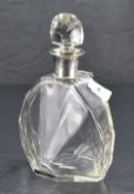An Art Deco period silver-mounted cut-glass decanter, having a domed facet-cut stopper over the