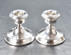 A pair of early Elizabeth II silver squat or dwarf candlesticks, with reed moulded decoration, marks