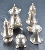A group of five silver pepperettes, each of varying size, design, age and maker, gross weight