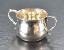 A George V silver two-handled bowl, of plain baluster form with two applied scroll handles, engraved
