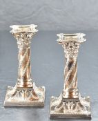 A pair of Victorian silver column candlesticks, having bead-moulded removable sconces over the