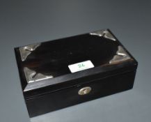 An Edwardian silver mounted ebony cigarette box, of hinged rectangular form with shaped silver
