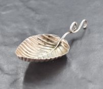 A George III silver caddy spoon, of moulded pointed oval leaf form with looped handle, marks for