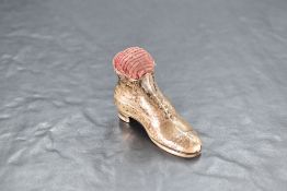 An Edwardian silver boot-form pin cushion, marks for Birmingham 1909, maker Robert Pringle & Sons,