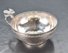 A continental white metal cup, of circular ogee form with moulded rim and band of repeating lappet
