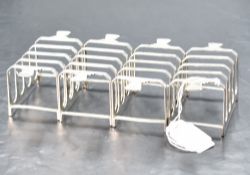 A group of four Art Deco design silver four division toast racks, each of rectangular form with