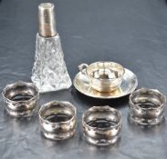 A 950 grade white metal miniature cup and saucer, of traditional design with band of reeded