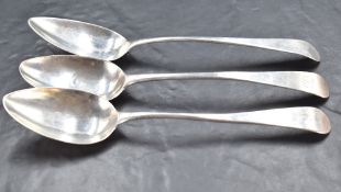 A Group of three George III silver table spoons, Old English pattern with Hanovarian reverse, each