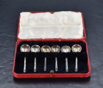 A cased set of six Art Deco design silver coffee spoons, each slender handle with chevron design
