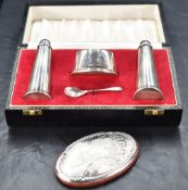 A cased Queen Elizabeth II silver three-piece condiment set, comprising salt cellar, pepperette