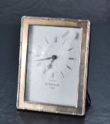 A Queen Elizabeth II silver mounted desk clock, of rounded rectangular form, with ribbon and