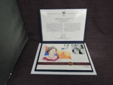 A Queen Elizabeth II Alderney 2002 Gold 25 Pound Coin on large hand painted Queen's Golden Jubilee