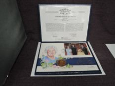 A Queen Elizabeth II Royal Mint 2002 Gold 1oz 5 Pound Coin on large hand painted Queen Mothers 100th