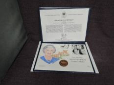 A Queen Elizabeth II Royal Mint 2002 Gold 1oz 5 Pound Coin on large hand painted Queen's Golden