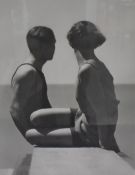 A reproduction monochrome photographic print, two sunbathers looking out to sea, within a card