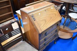 An early 20th century golden oak bureau