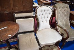 A Victorian mahogany nursing chair having spindle detailing and later dralon upholstery