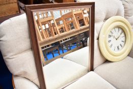 A modern mahogany effect wall mirror, approx. 89 x 54cm