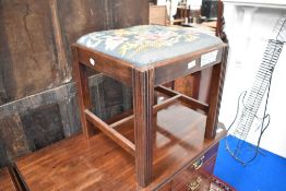 A 19th Century mahogany dressing stool having drop in woolwork seat