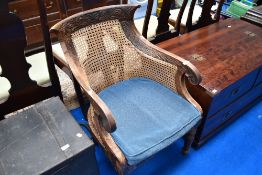A bergere back armchair having scroll frame and carved decoration