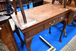 A 19th Century mahogany fold over tea table having frieze drawer and cabriole legs